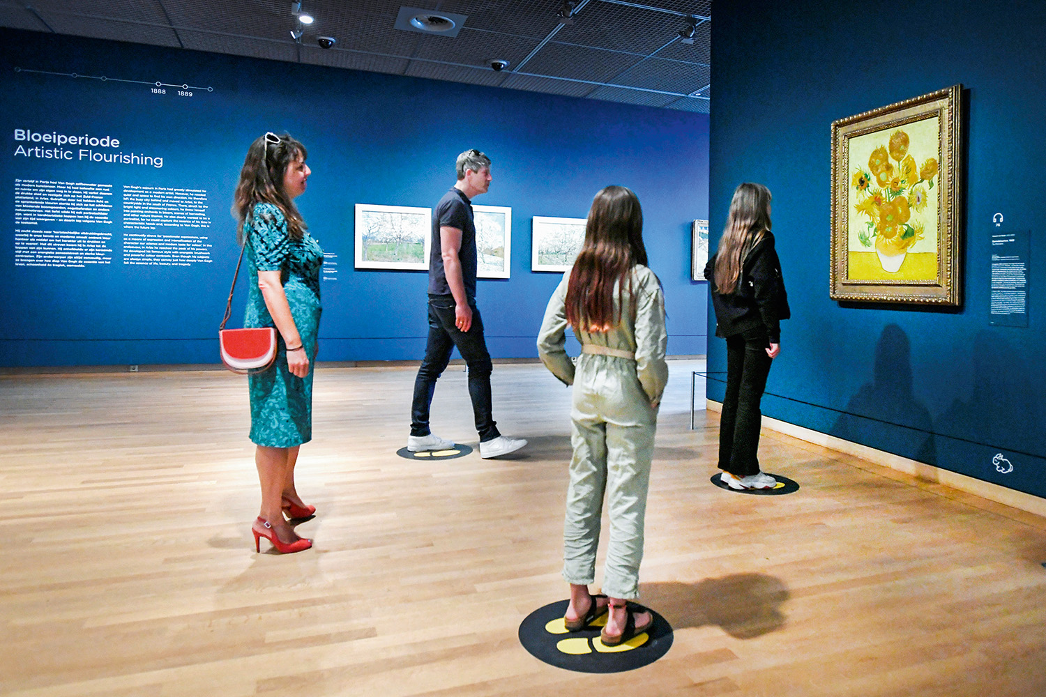 People look at Vincent van Gogh&rsquo;s Sunflowers painting at the Van Gogh Museum that reopened as Netherlands eases some of the lockdown measures