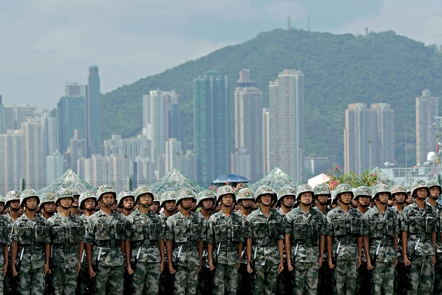 FILE PHOTO: The People&rsquo;s Liberation Army (PLA) soldiers take part in a performance during an open day of Stonecutters Island naval base, in Hong Kong