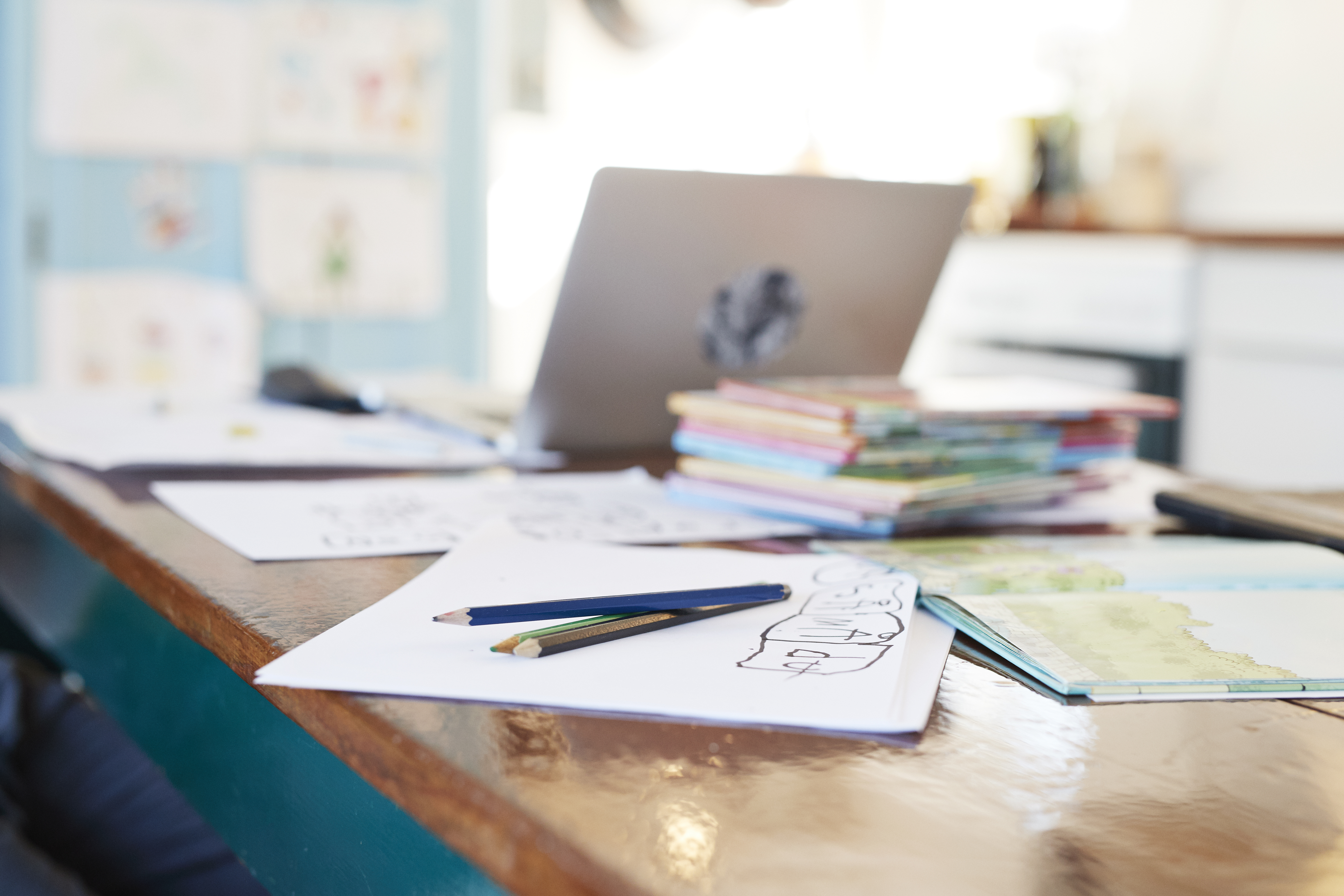 Colored pencils and school books on dining table