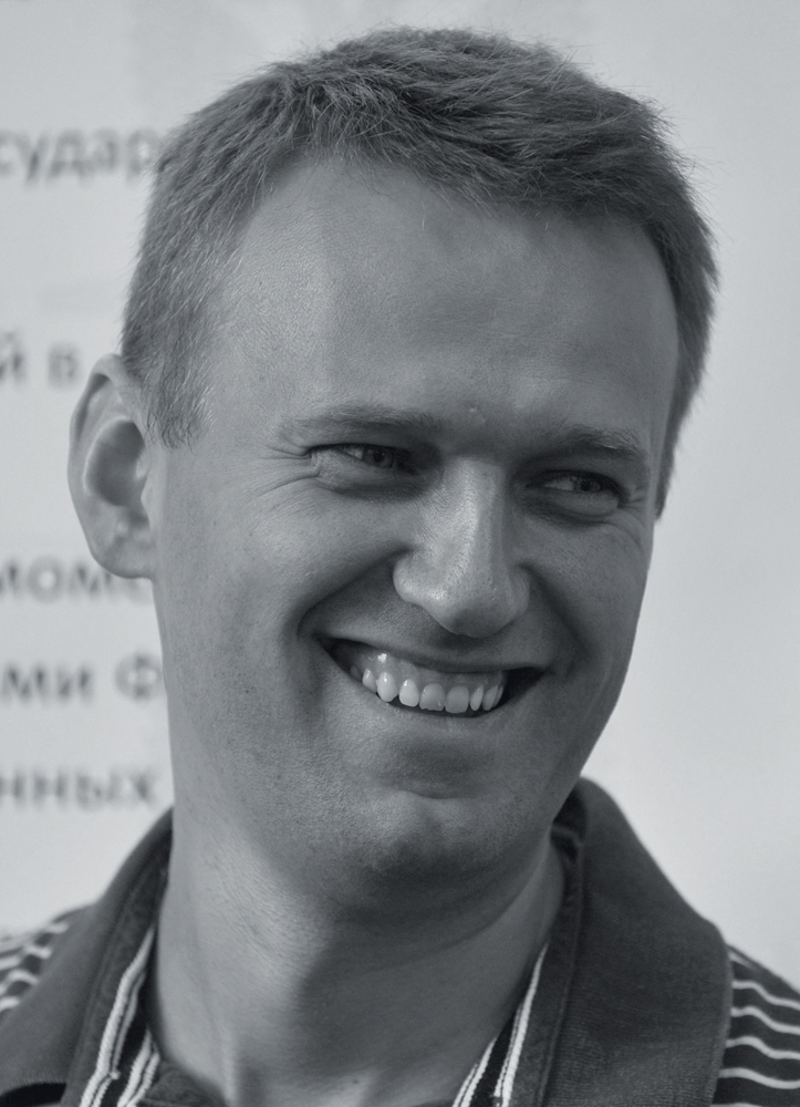 Russian opposition politician and blogger Alexey Navalny smiles as he attends a summer camp called Anti-Seliger in the Khimki forest, outside Moscow, on June 18, 2011. Anti-Kremlin opposition activists, bloggers, environmentalists and human rights defenders gathered in a forest of the northwestern outskirts of the Russian capital for a festival called Anti-Seliger, a reference to the annual event organized at Lake Seliger by pro-Kremlin youth movement &igrave;Nashi&icirc;. AFP PHOTO / ANDREY SMIRNOV (Photo by ANDREY SMIRNOV / AFP)