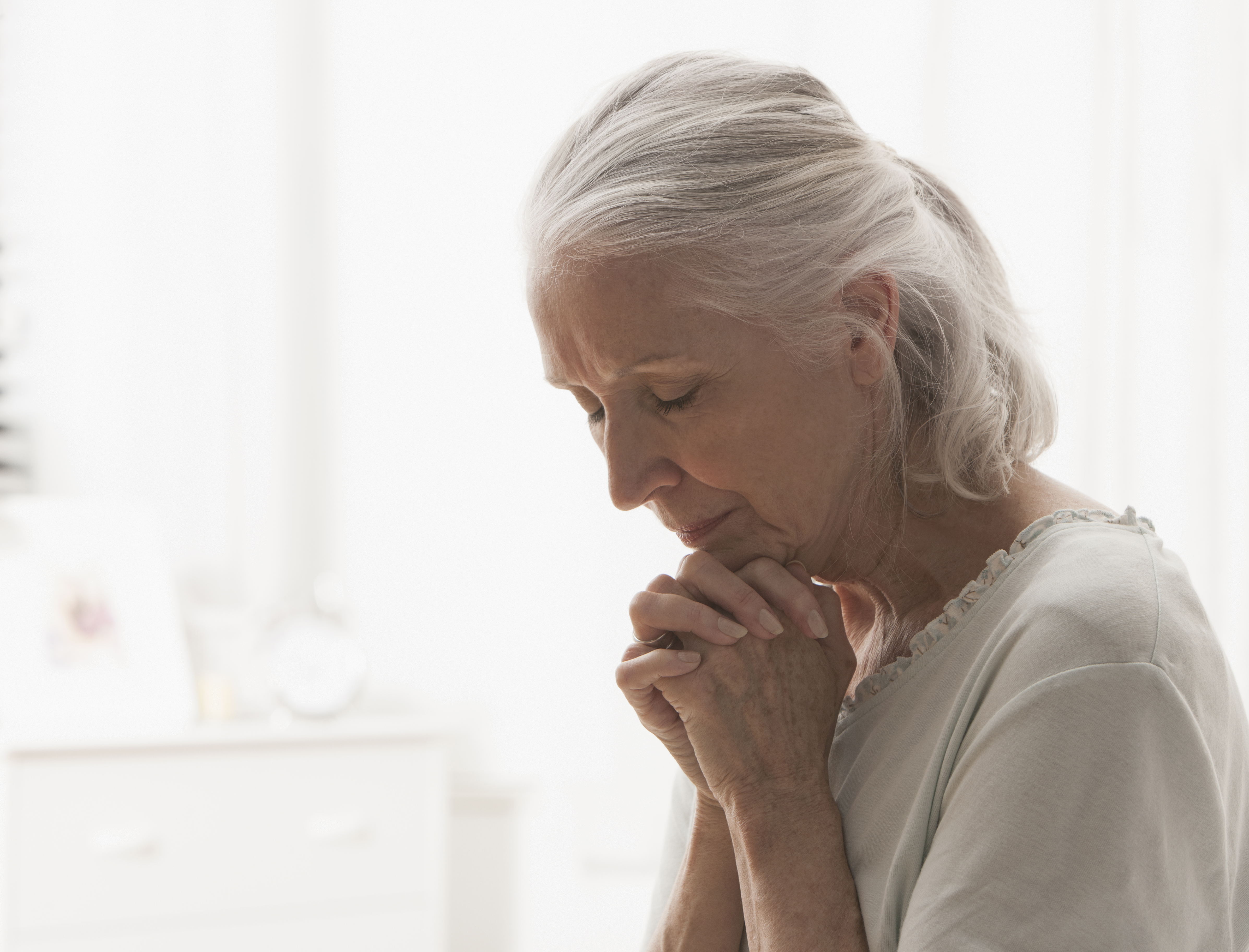 Senior Caucasian woman praying