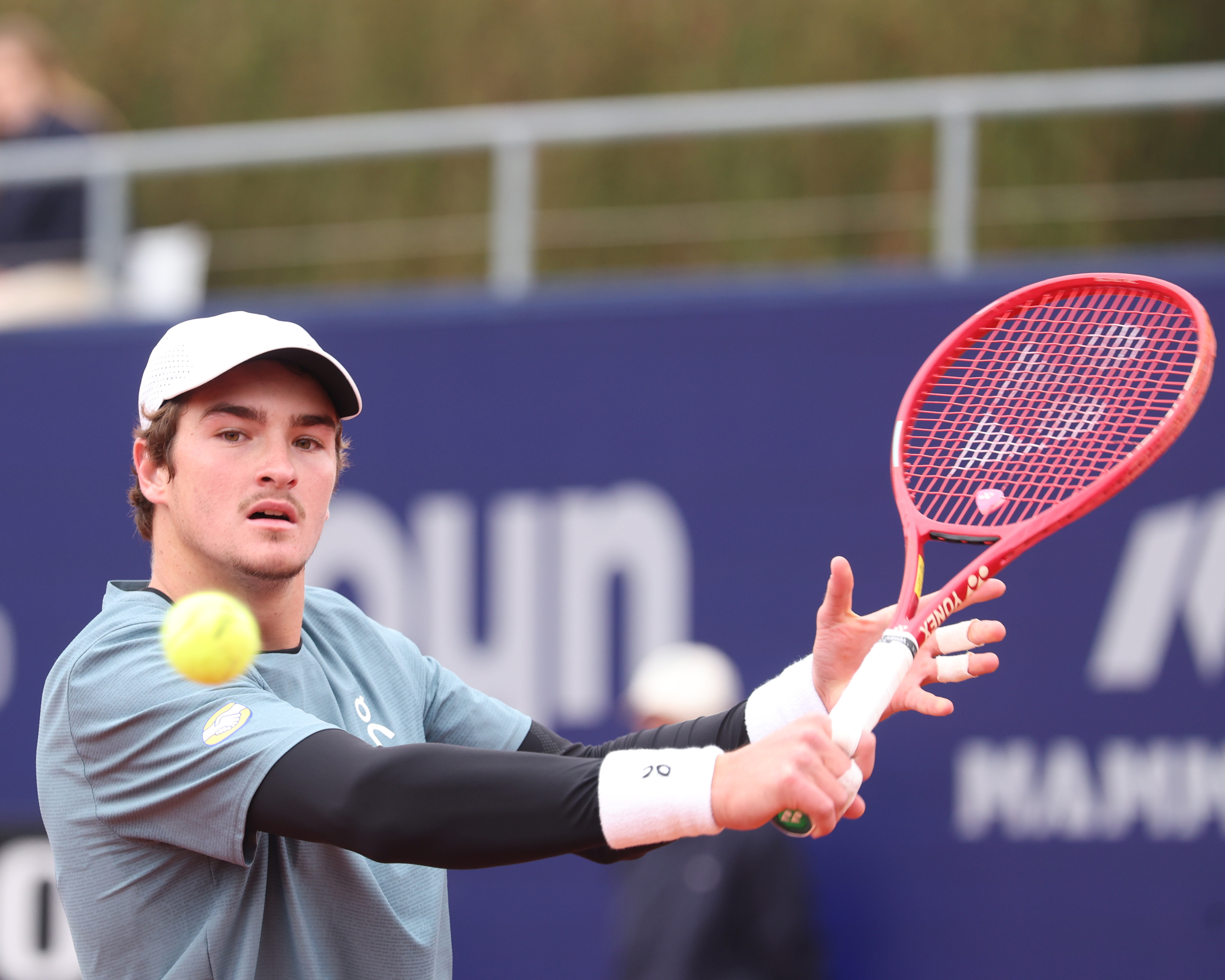 MUNICH, GERMANY - APRIL 15: Joao Fonseca of Brazil plays a backhand as he plays against Arthur Rinderknech of France during day five of the BMW Open at MTTC IPHITOS on April 15, 2026 in Munich, Germany. (Photo by Alexander Hassenstein/Getty Images for BMW)